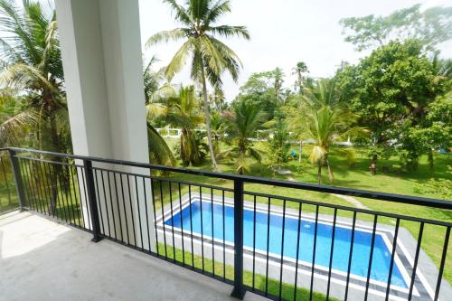 a balcony with a view of a swimming pool at Welpalla Signature 
