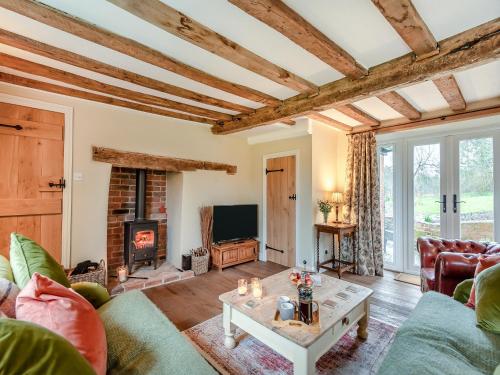 a living room with a couch and a fireplace at Hill Farm in Blyford