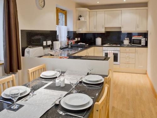 a kitchen with a table with plates on it at Willow Cottage - E4778 in Atwick