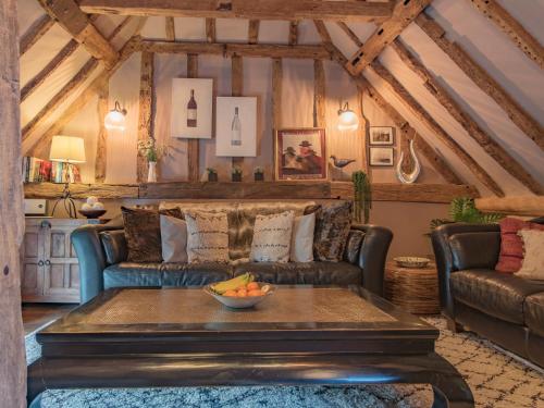 a living room with a couch and a table at Woolhouse Barn in Hunton