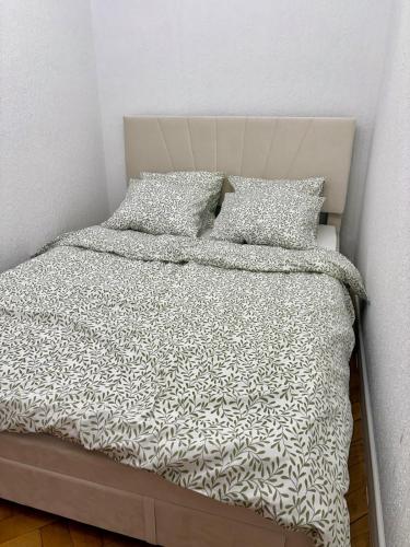 a bed with two pillows on top of it at MW Leo Apartament in Konin
