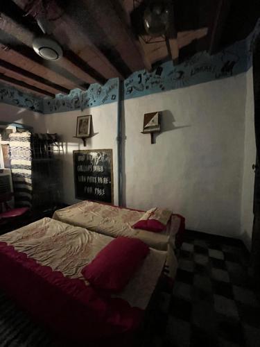 a bedroom with a bed with a sign on the wall at Peacock guest house in Aswan