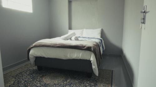 a bedroom with a bed with a teddy bear on it at Halaal Serenity 3bedroom 6sleeper in Cape Town