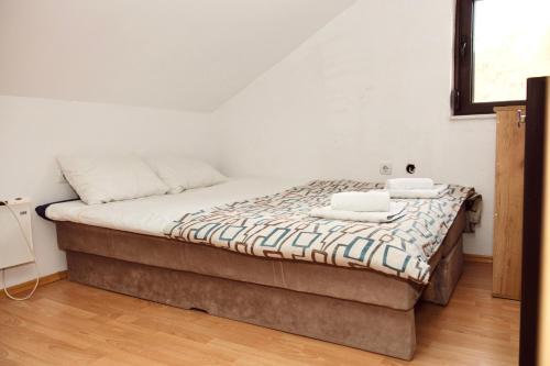 a bed with two towels on it in a room at Srce Kozare in Prijedor