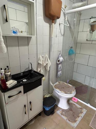 a dirty bathroom with a toilet and a shower at Casa da Nise in São Gabriel