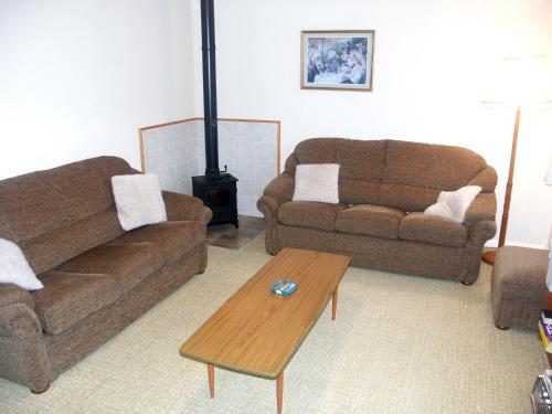 a living room with two couches and a coffee table at Fell Croft in Pooley Bridge