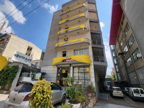 a tall building with a car parked in front of it at South gate hotel in Addis Ababa
