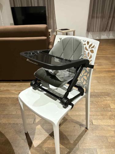a white chair with a glass table on top of it at Appt RDC meublé 2 ou 4 pers in Blagny