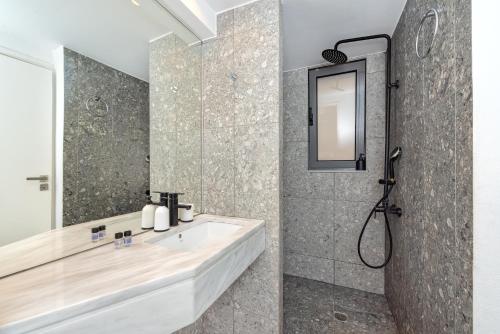 a bathroom with a sink and a shower at Central cozy garden flat in Mesochórion