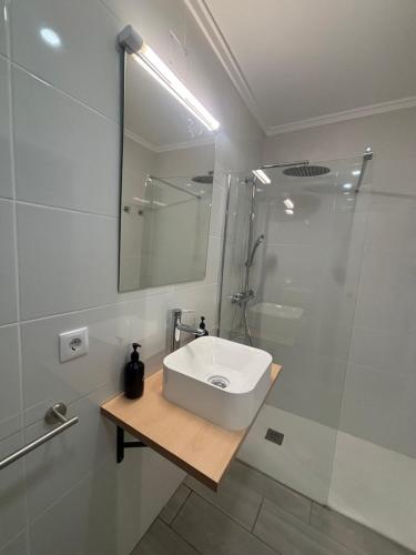 a white bathroom with a sink and a shower at Origen Bed and Breakfast in Villargordo del Cabriel
