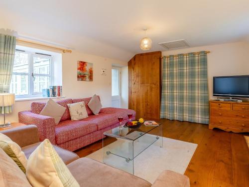 a living room with a couch and a tv at Long Barn - Uk30435 in Kingsbury Episcopi