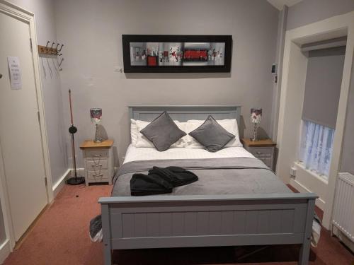 a bedroom with a bed with two pillows on it at Studio flat - An Bonnan Bui in Rathmullan