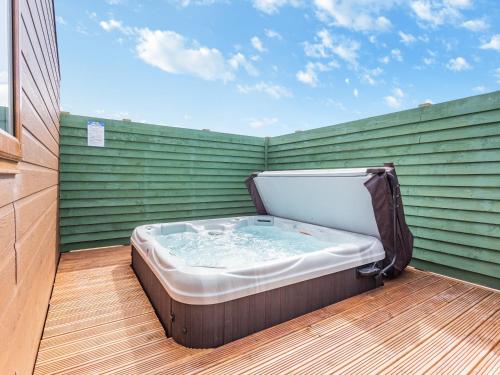 a hot tub sitting on top of a deck at Burray in Mey