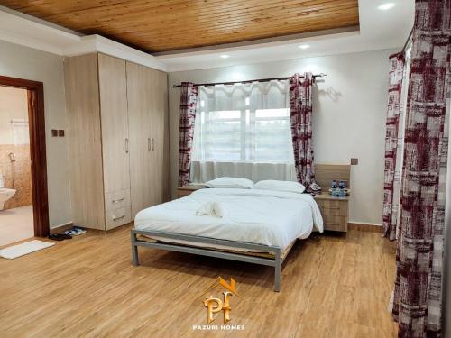 Ένα ή περισσότερα κρεβάτια σε δωμάτιο στο Pazuri Villas