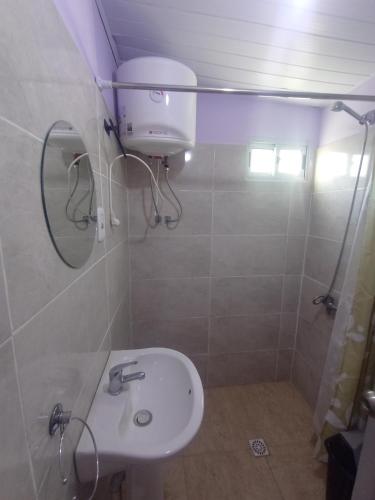 a bathroom with a white sink and a shower at Pe-Pé Pe-Pé in Estación Costa Azul
