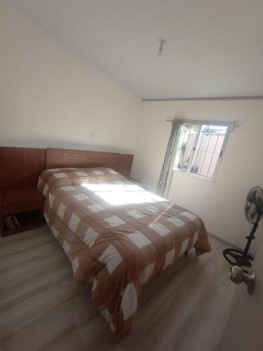 a bedroom with a bed in a room with a window at Pe-Pé Pe-Pé in Estación Costa Azul