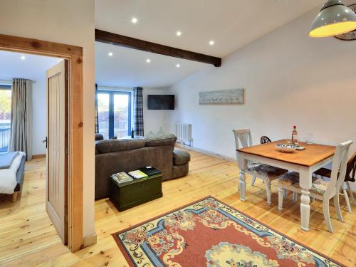 a living room with a table and a couch at Dornfelder - Ukc3209 in Newbridge