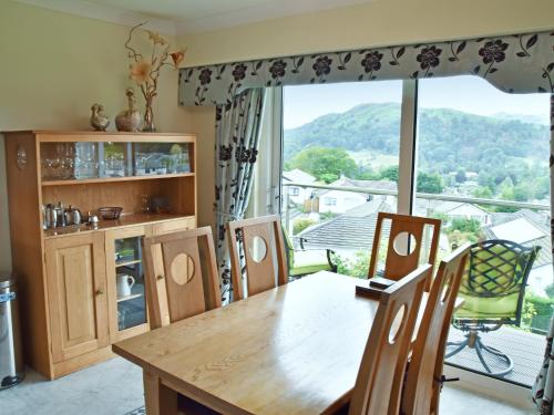 a dining room with a table and a large window at Badgers Rake 12 Squirrels Nest in Ambleside