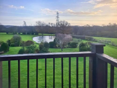 a view from a balcony of a golf course at Moorhens in Herstmonceux