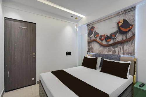 a bedroom with a bed with a painting on the wall at Hotel O Royal Fourtune in Utrān