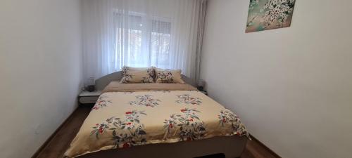 un piccolo letto in una stanza con una finestra di La Bloc Apartment a Arad