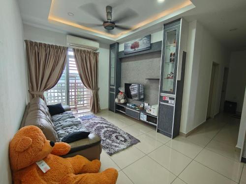 a living room with a couch and a teddy bear at Kalista1 Seremban 2 in Seremban