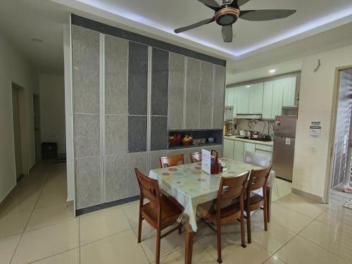 a kitchen with a table with chairs and a ceiling fan at Kalista1 Seremban 2 in Seremban