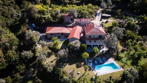 an overhead view of a house with a swimming pool at Quinta do Assento in Louredo