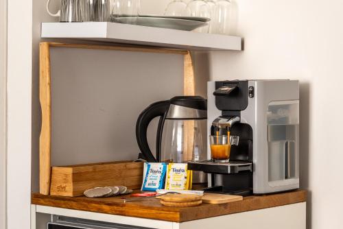 a coffee maker on a shelf in a kitchen at Le Bourget - Envolée Romantique in Narbonne
