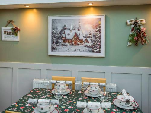 a dining room with a table with a christmas at Christmas Cottage in Cheddar