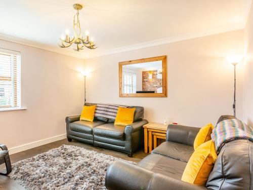 a living room with a couch and a chair at Church View in Barmby on the Marsh