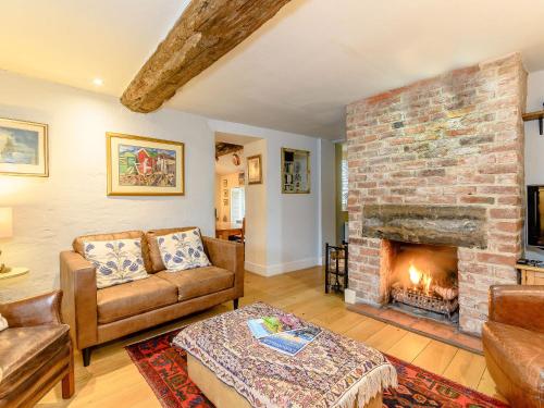 a living room with a couch and a fireplace at The Smithy - E5445 in Brassington