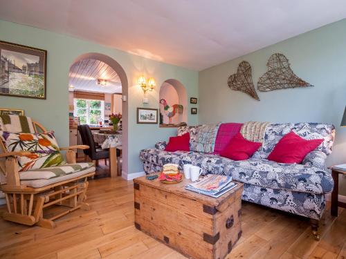 a living room with a couch and a table at Crows Cottage in Fishguard