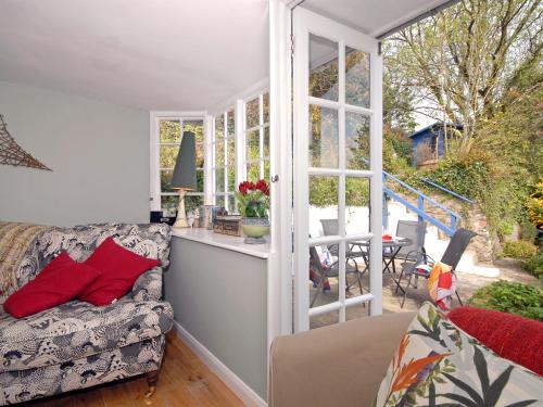 a living room with a couch and a window at Crows Cottage in Fishguard