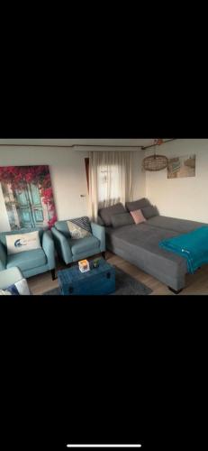 a living room with a couch and a bed at Luxus Chalet Wattenmeerblick in Westerland