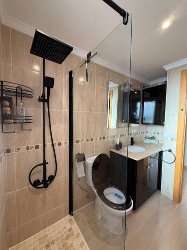 a bathroom with a shower and a toilet and a sink at Motel Mary in Jávea