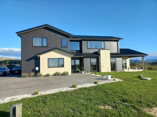 a house with a car parked in a driveway at Awesome accomodation-Aokautere in Palmerston North