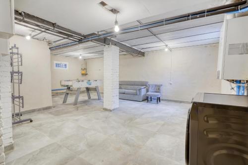 a room with a couch and a table in it at Maison familiale proche Paris et transport 8 personnes in Maisons-Alfort