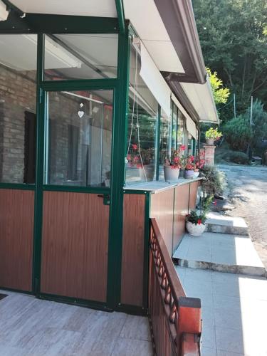 a porch with a glass door and a bench at B&B Oasi di pace in Rocca deʼGiorgi