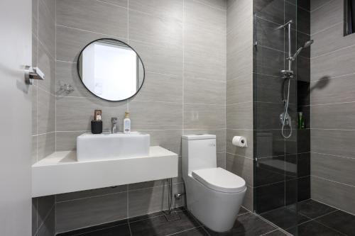 ein Badezimmer mit Waschbecken, Toilette und Spiegel in der Unterkunft Trion Kuala Lumpur by Vivid Stay in Kuala Lumpur