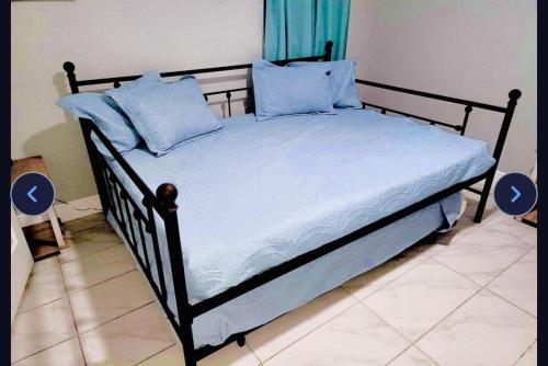 a bed with blue pillows on it in a room at House of Manatees-Entire house with yard, fire pit, dog friendly in Crystal River