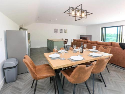 a dining room with a wooden table and chairs at Oaktree Cottage - 3 Bedrooms - Sleeps 6 in Frizington