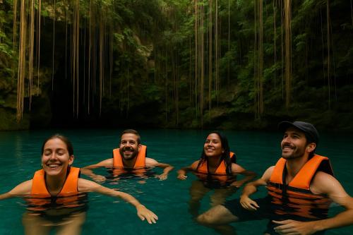 a group of people swimming in the water at ARKA Tulum in Tulum