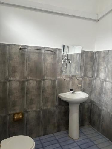 a bathroom with a sink and a toilet at Amis Hotel & Restaurant in Jaffna