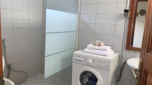 a washing machine in a bathroom with a washer at Maya, Entire Apartment, Mbour, 3 air-conditioned bedrooms in Mbour