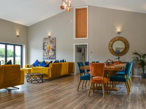 a living room with a table and chairs and a couch at Dodds Barn in Fersfield