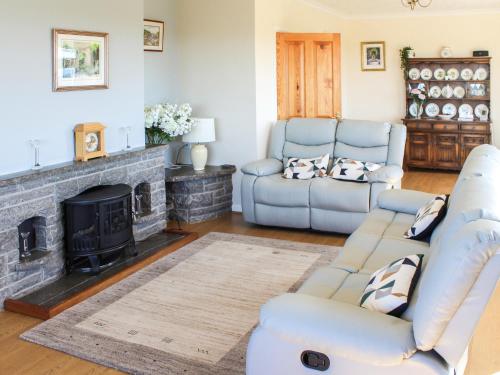 a living room with couches and a fireplace at Rhandir-Mwyn - Hw7110 in Llandwrog