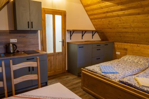 a small kitchen with a bed in a room at U Kováře Matěje in Dřevíkov