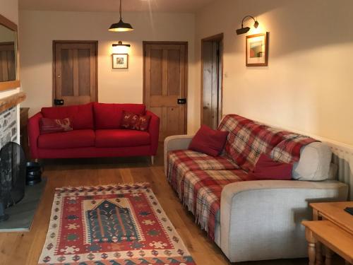 a living room with two couches and a red couch at Overwater Lodge in Bassenthwaite Lake