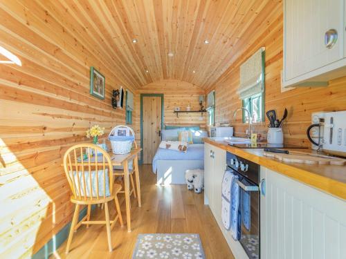 a kitchen with wooden walls and a wooden ceiling at Cater Tober Haven in Dunnet